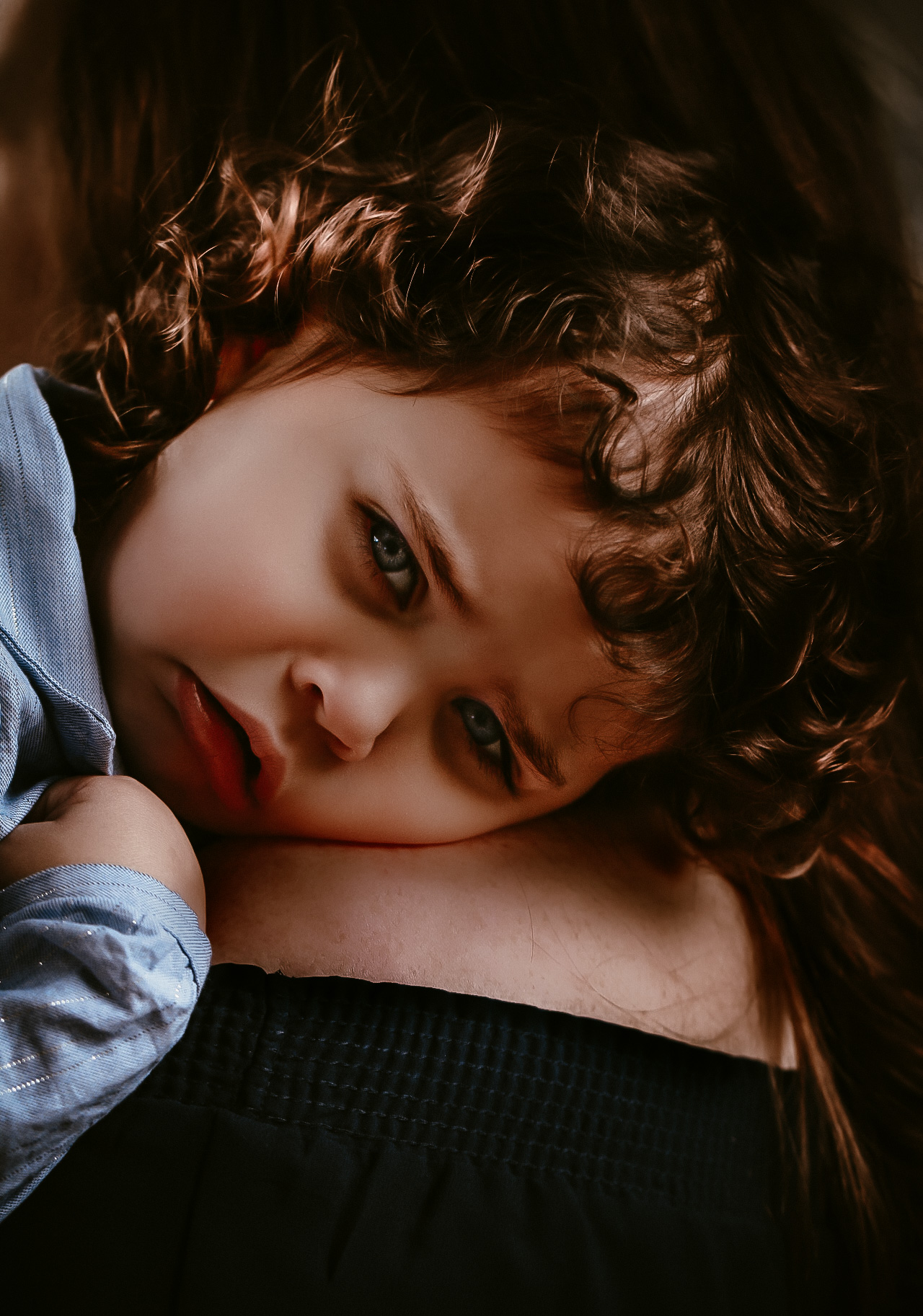 Little girl laying on her dad's shoulder making at sad face- location at a waterfall in Atlanta, Georgia