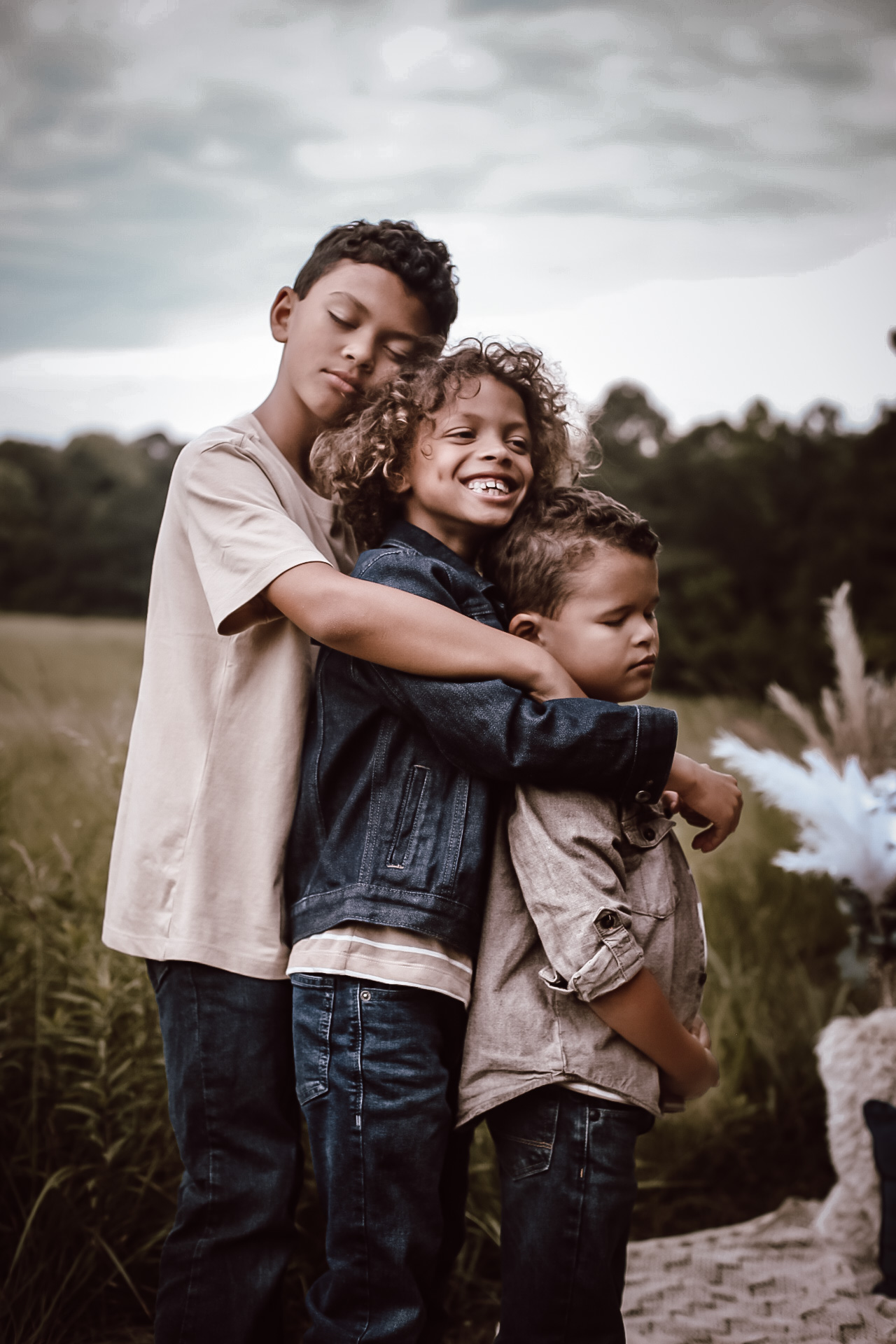 Three brothers hugging eachother with their eyes closed. Fall Family photography - - Green Meadow Preserve Family photo