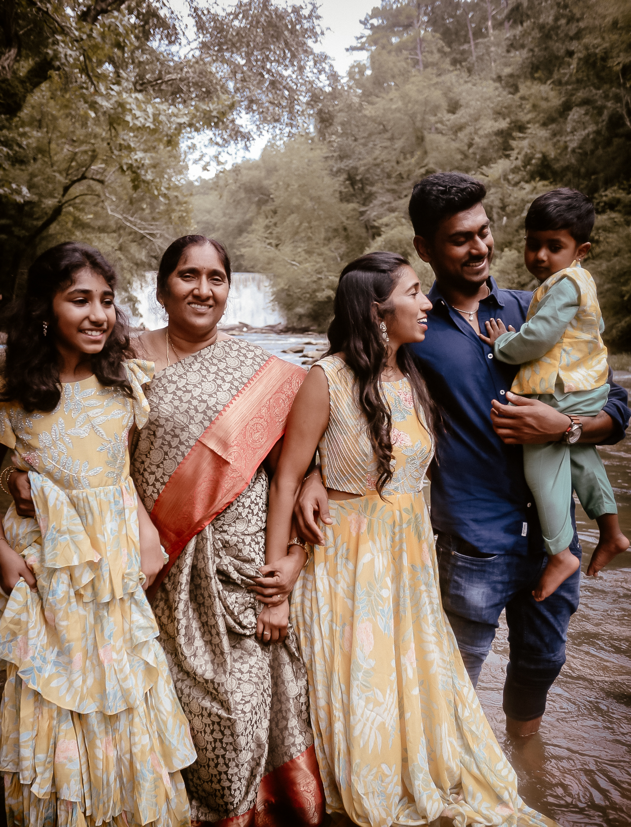 Indian Family of 5 Photography at roswell Mill in Atlanta, Ga all looking at each other and smiling