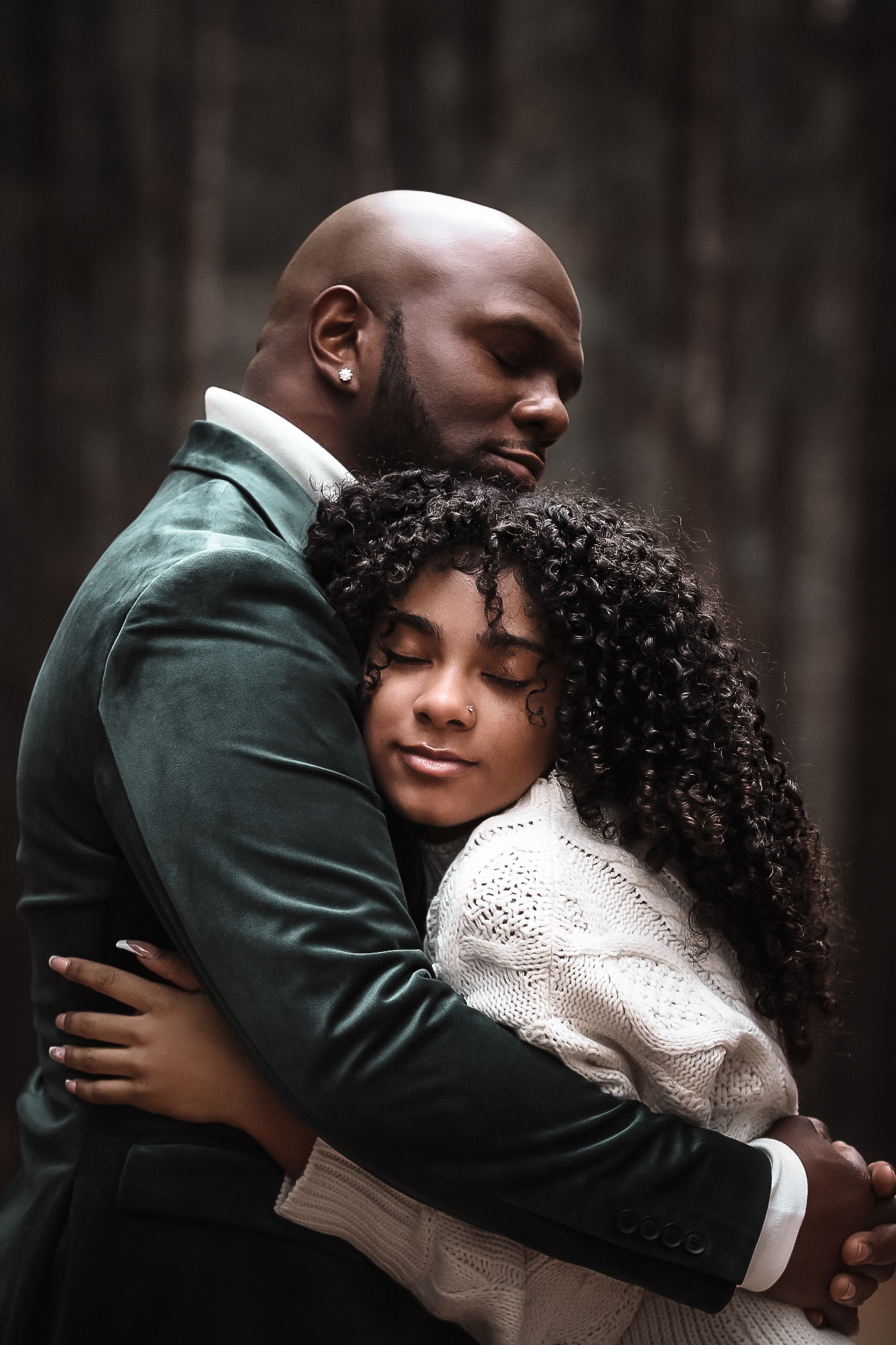 Oldest daughter hugging her dad while both of their eyes are closed. Fall Family photography - - Arabia Mountain Portrait Photography