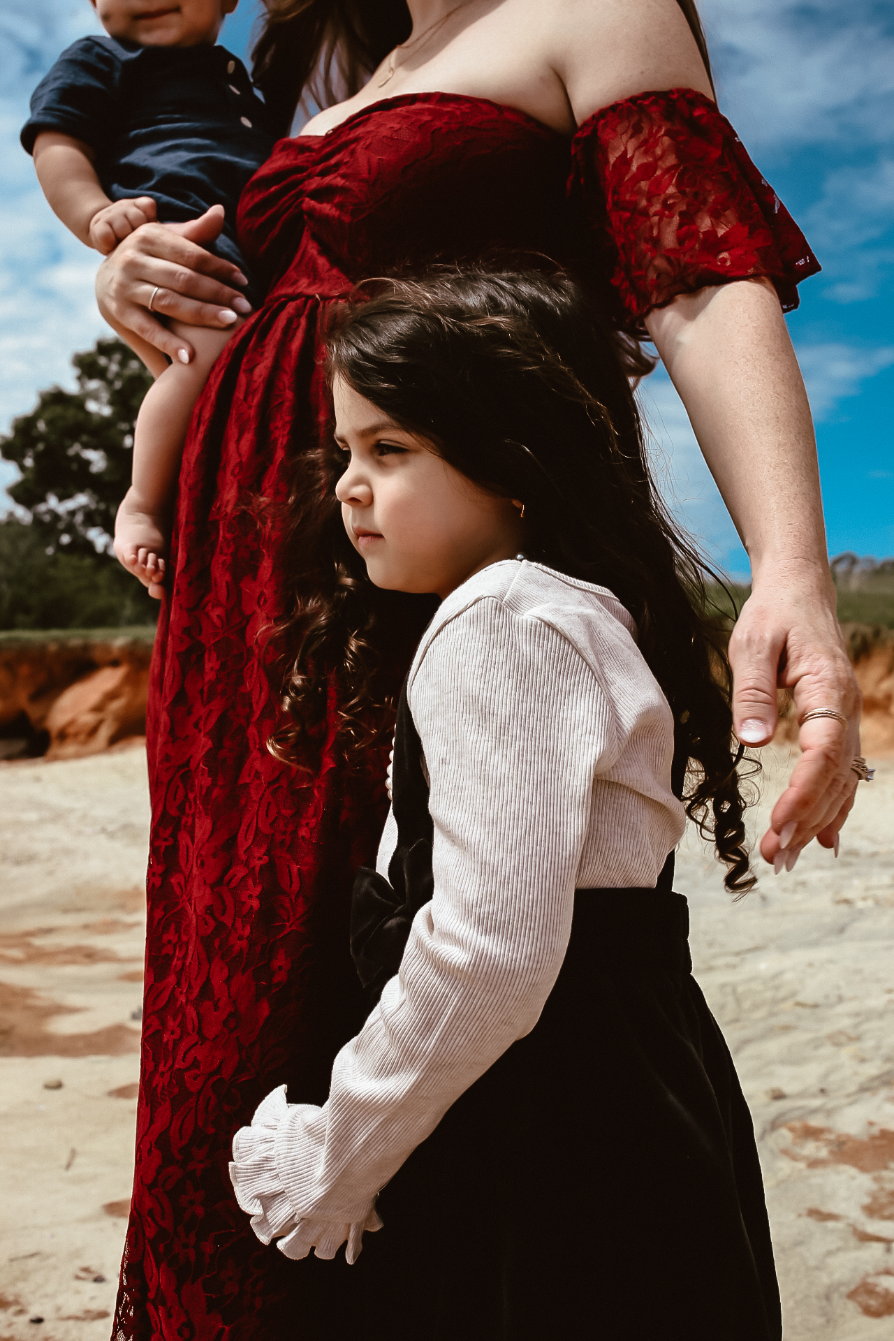 Little girl hugging her mom's leg while looking at the water at Lake Lanier