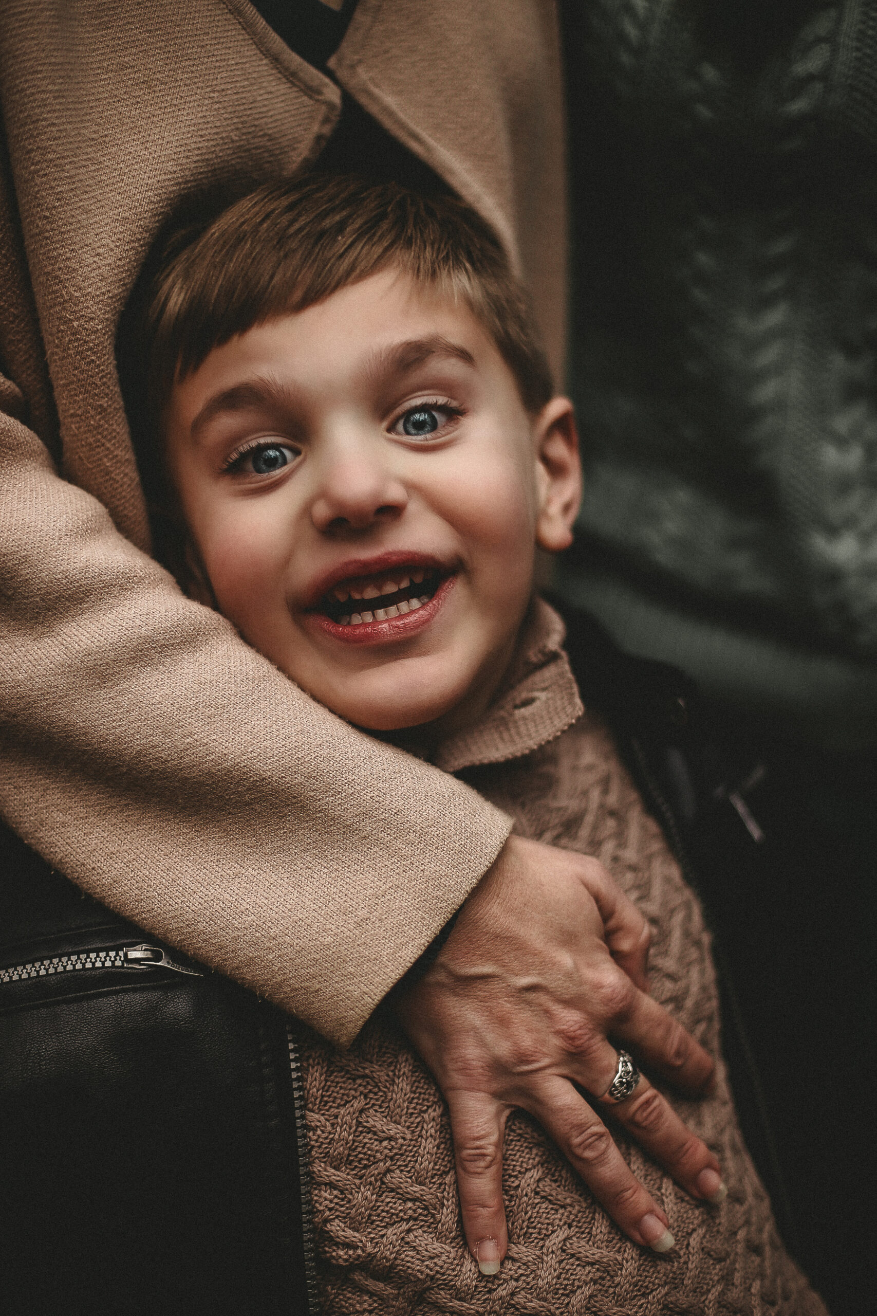 Close up of young boy laughing and smiling a the camera