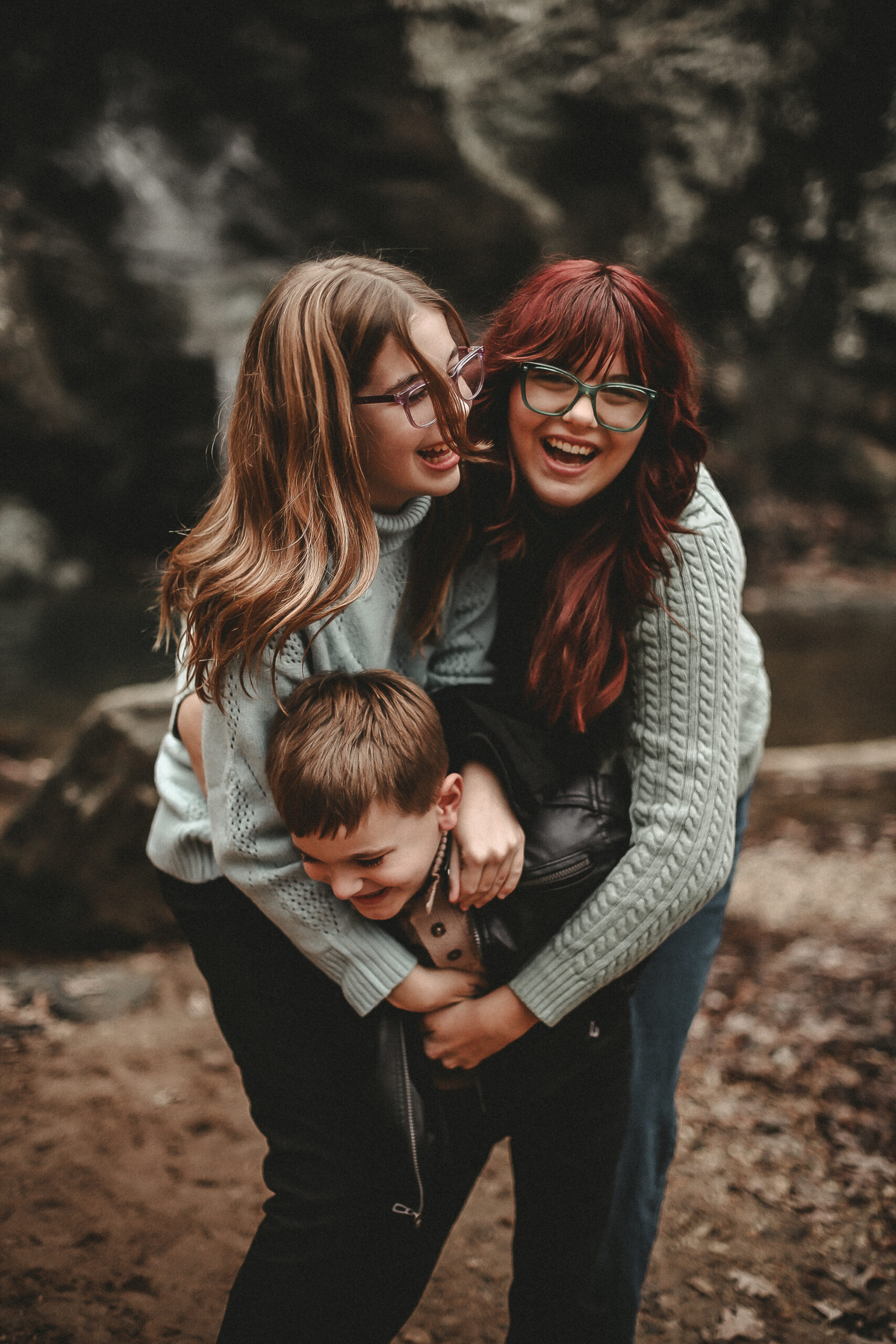 Portrait of 3 siblings hugging and laughing while at a waterfall - High Shoals Falls, Dallas, Ga