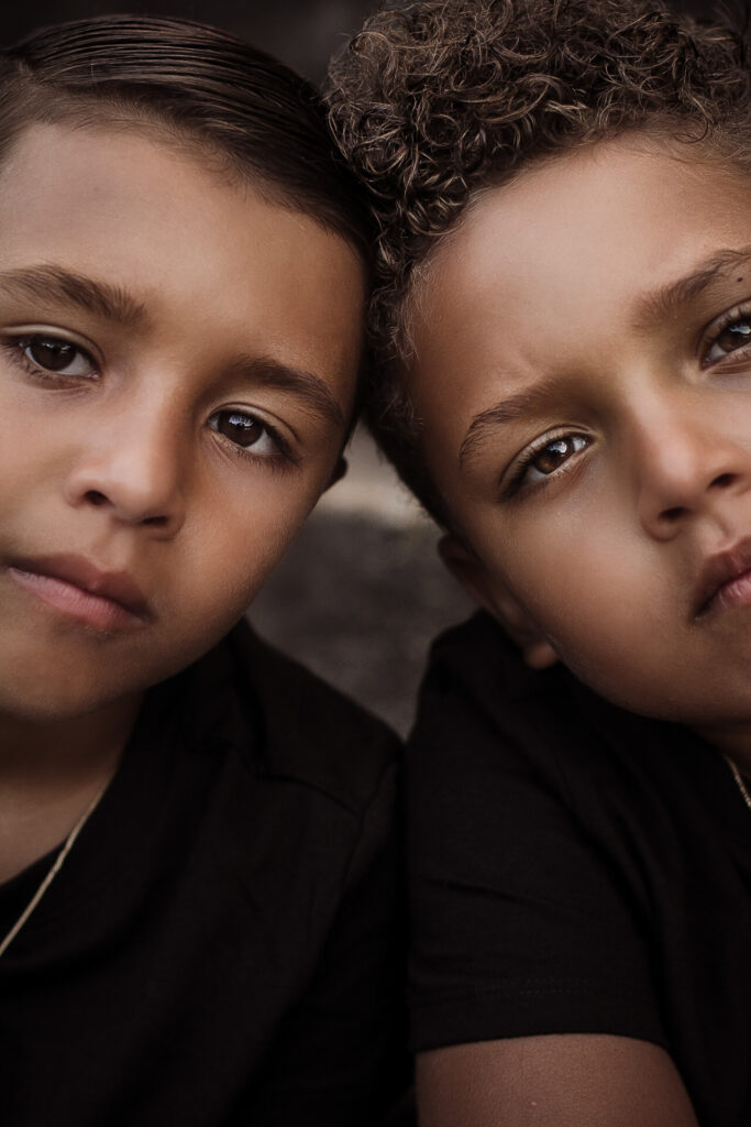Portrait of two young brothers staring at the camera up close